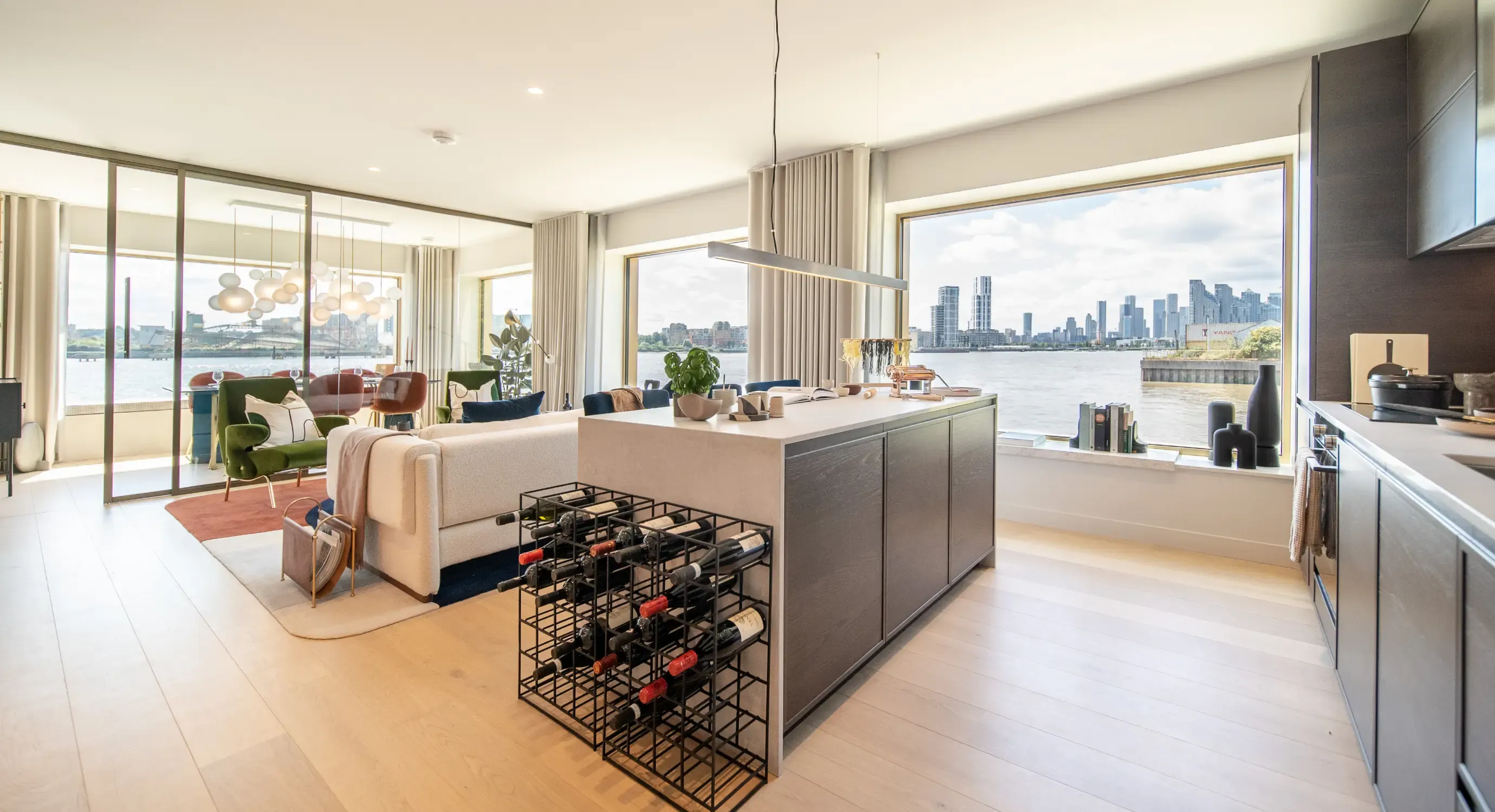 Open-plan living room with floor-to-ceiling windows over the river