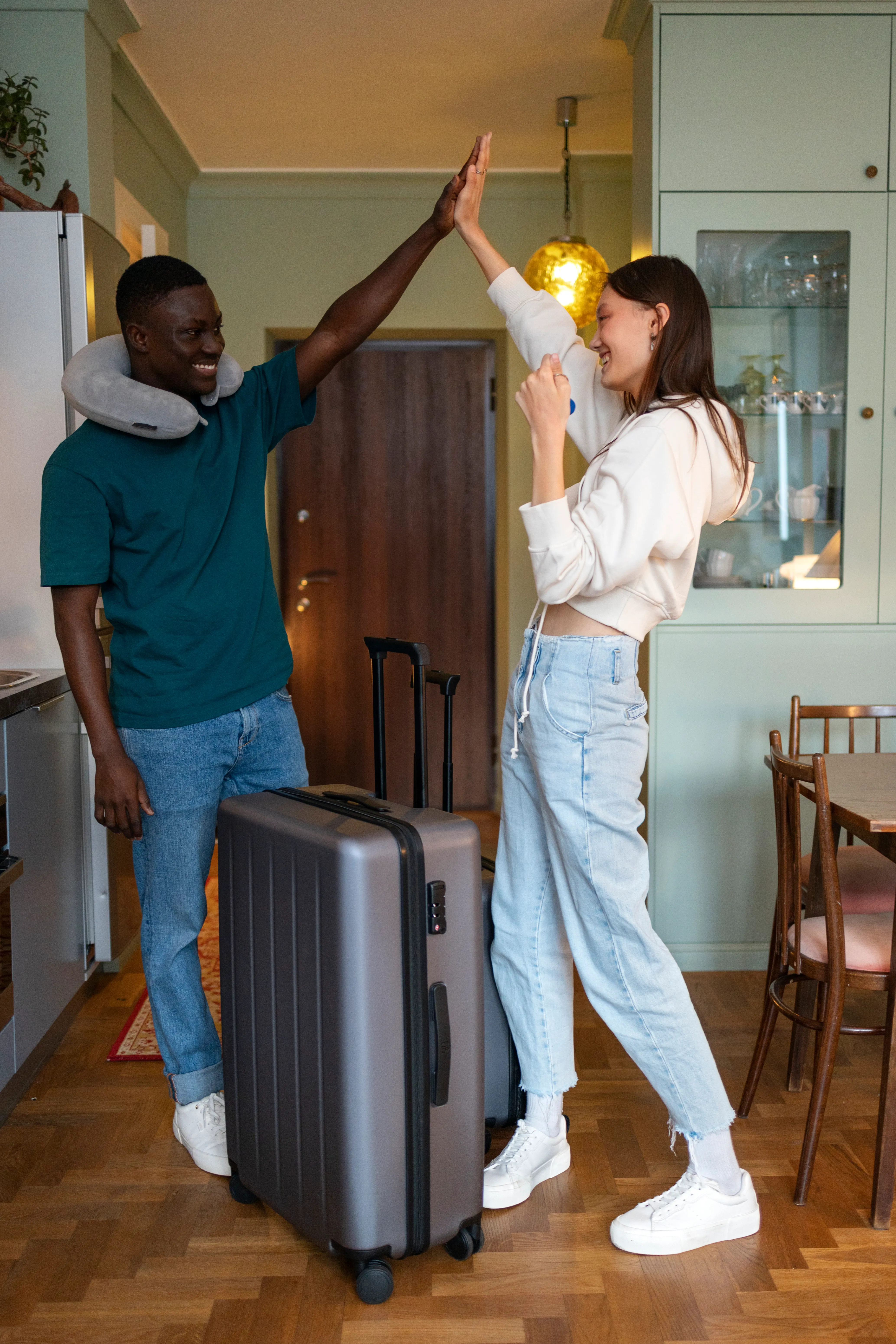 Hosts greeting arriving guests in a hallway