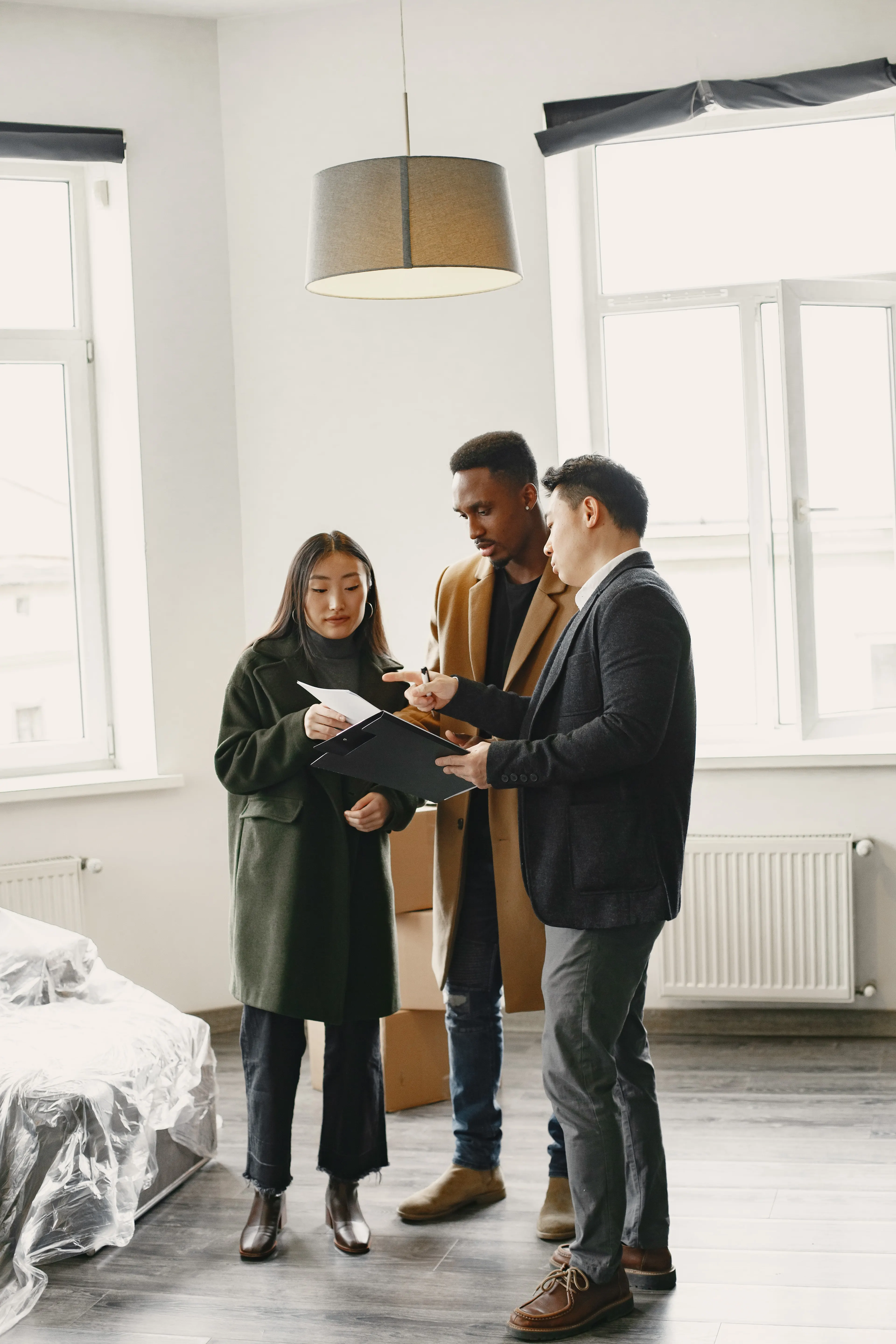 A couple signing the paperwork on a new home