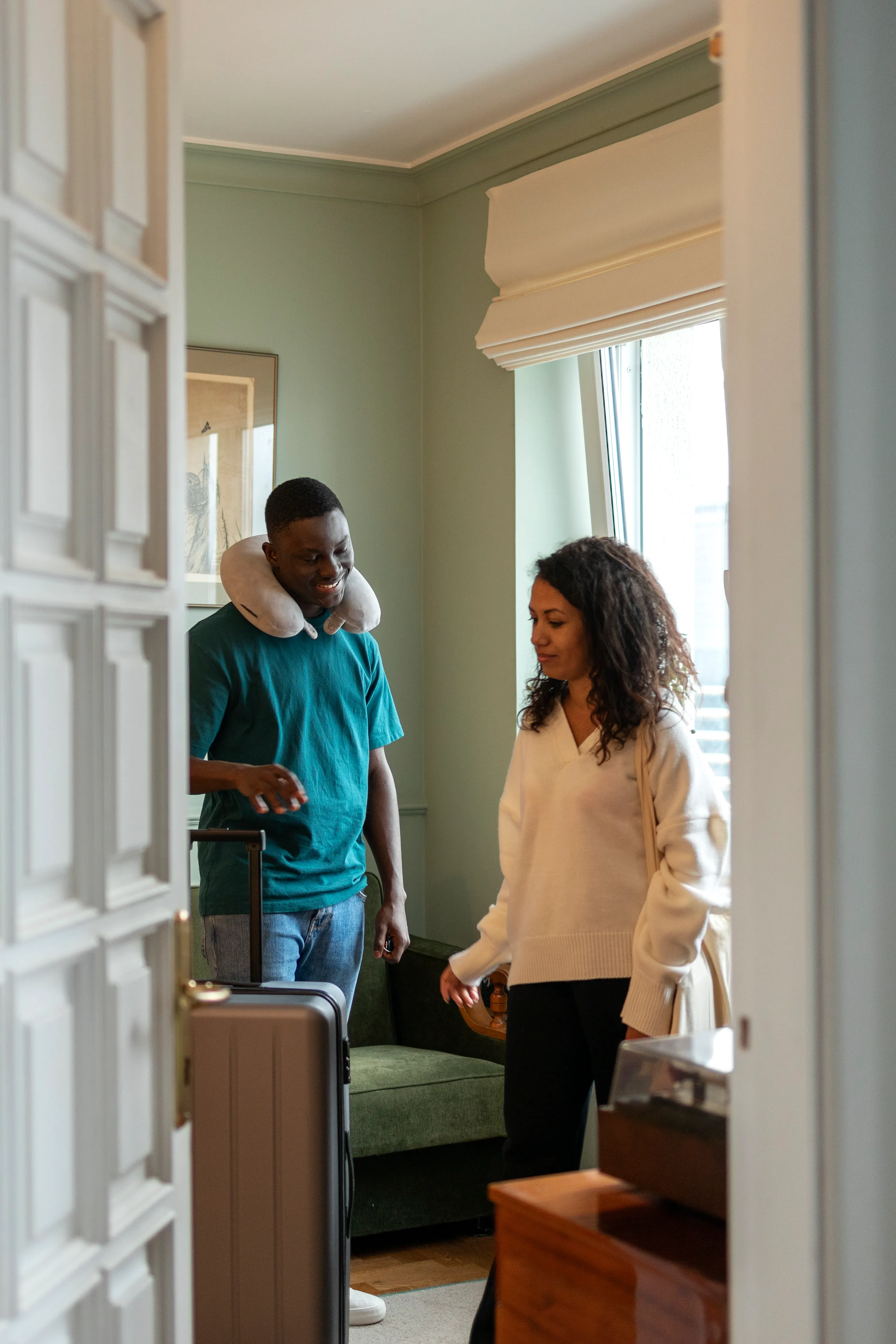 A host welcoming guests at the front door